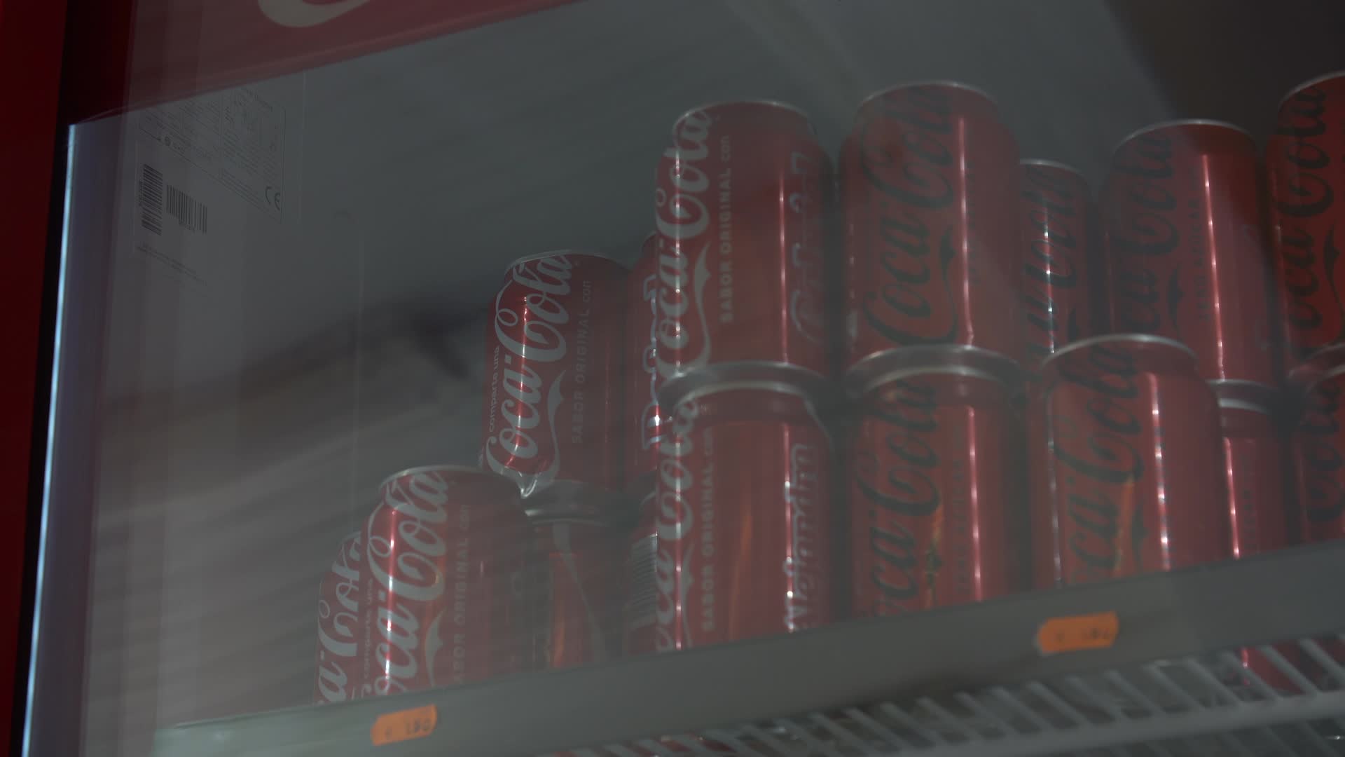 Coca-Cola Cans in Refrigerated Display Case