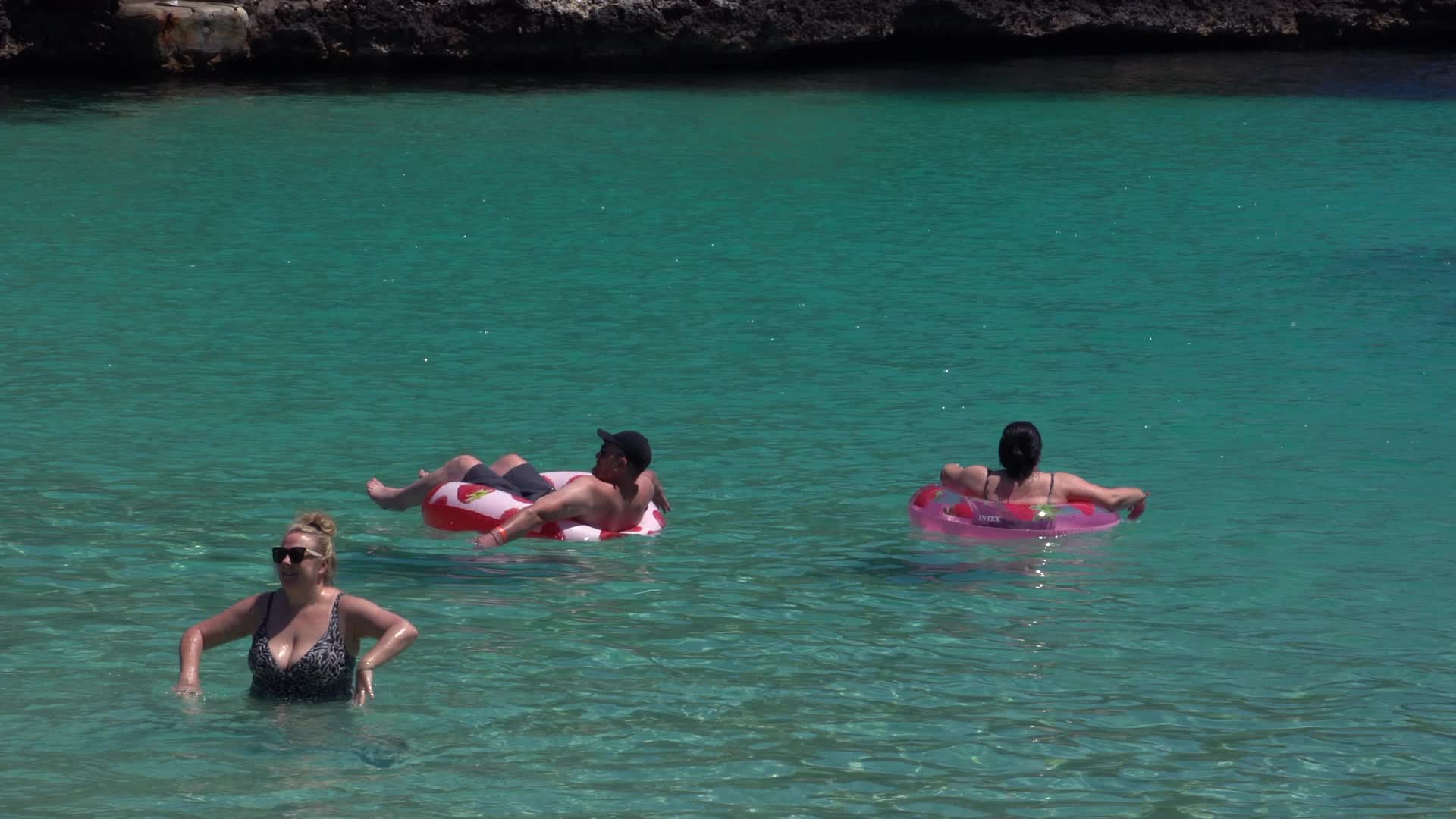 Tourists Relaxing in the Sea at Cala d'Or, Mallorca, Spain Beach