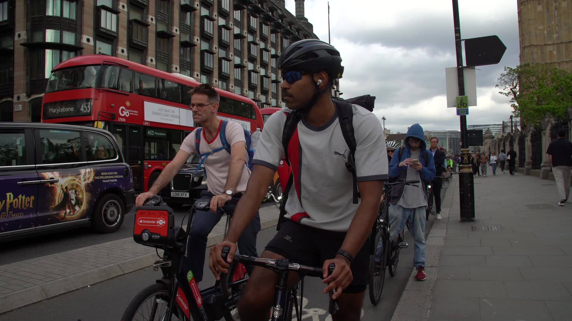 Cyclists on Westminster Street with Red London Bus 