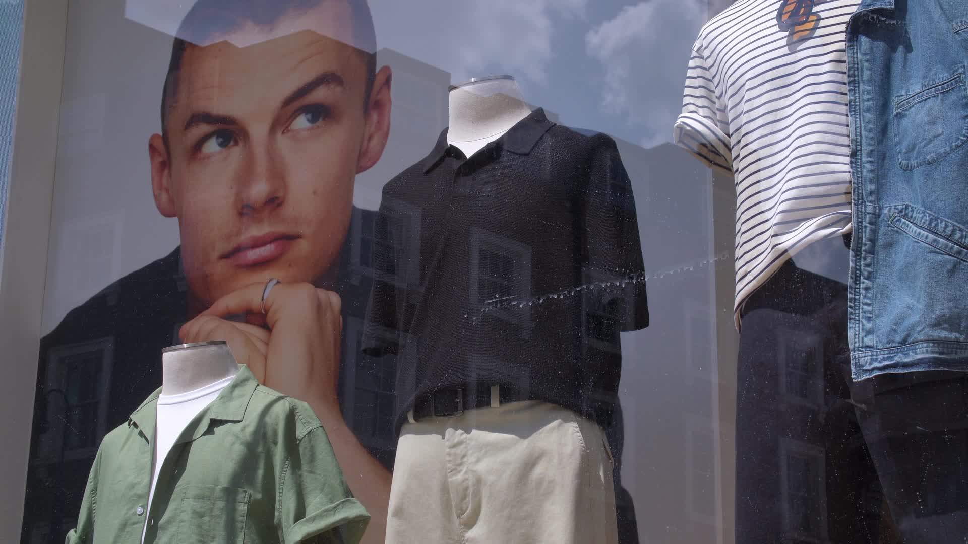Fashion Window Display with Mannequins and Poster