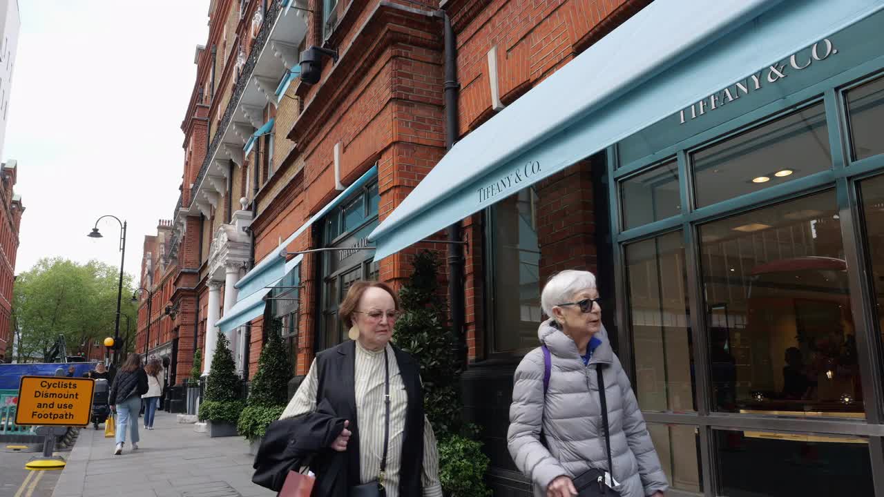 Pedestrians Walking Past Tiffany & Co. Storefront in London