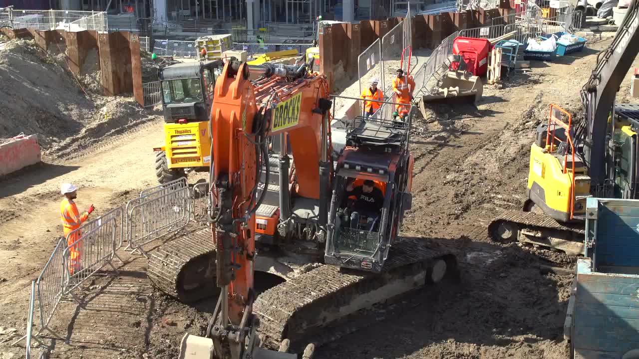 Busy Urban Construction Site with Machinery and Workers