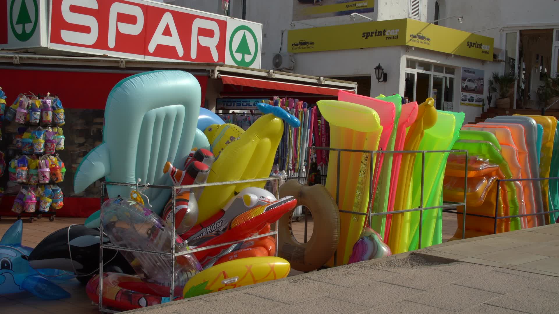 SPAR Storefront with Inflatable Pool Toys Display in Cala d'Or, Mallorca, Spain