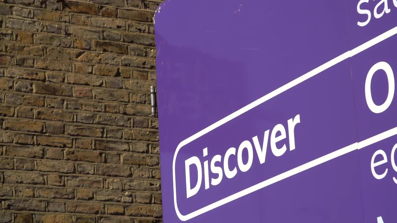 Discover Sign Against Brick Wall