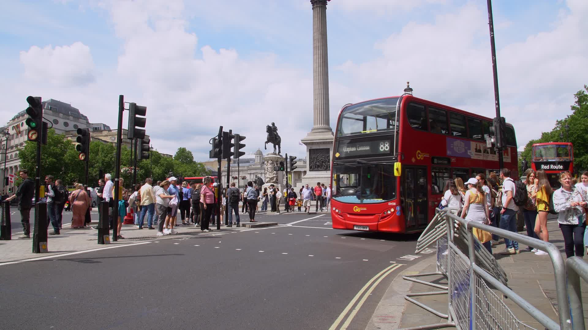 Busy Trafalgar Square with Nelson's Column and Traffic