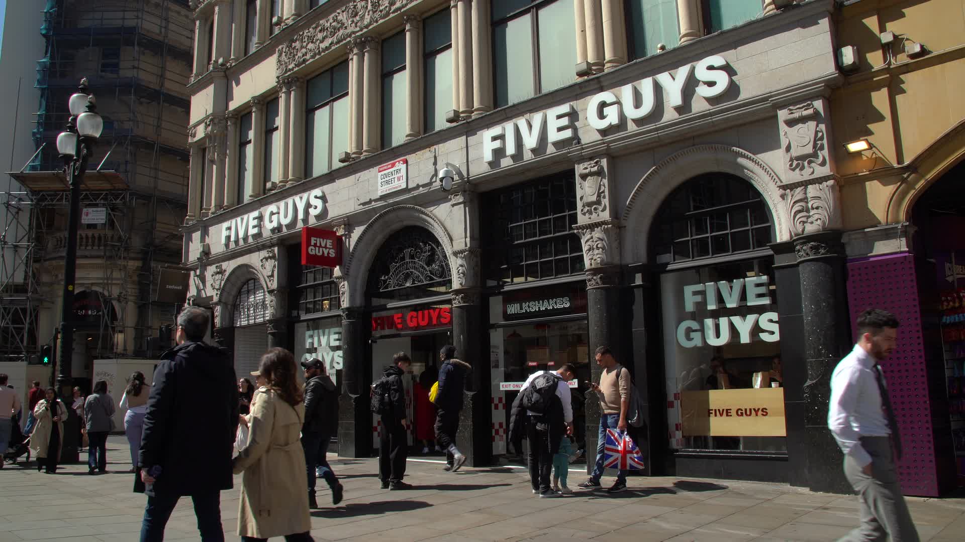 Five Guys Restaurant Exterior on Bustling Street