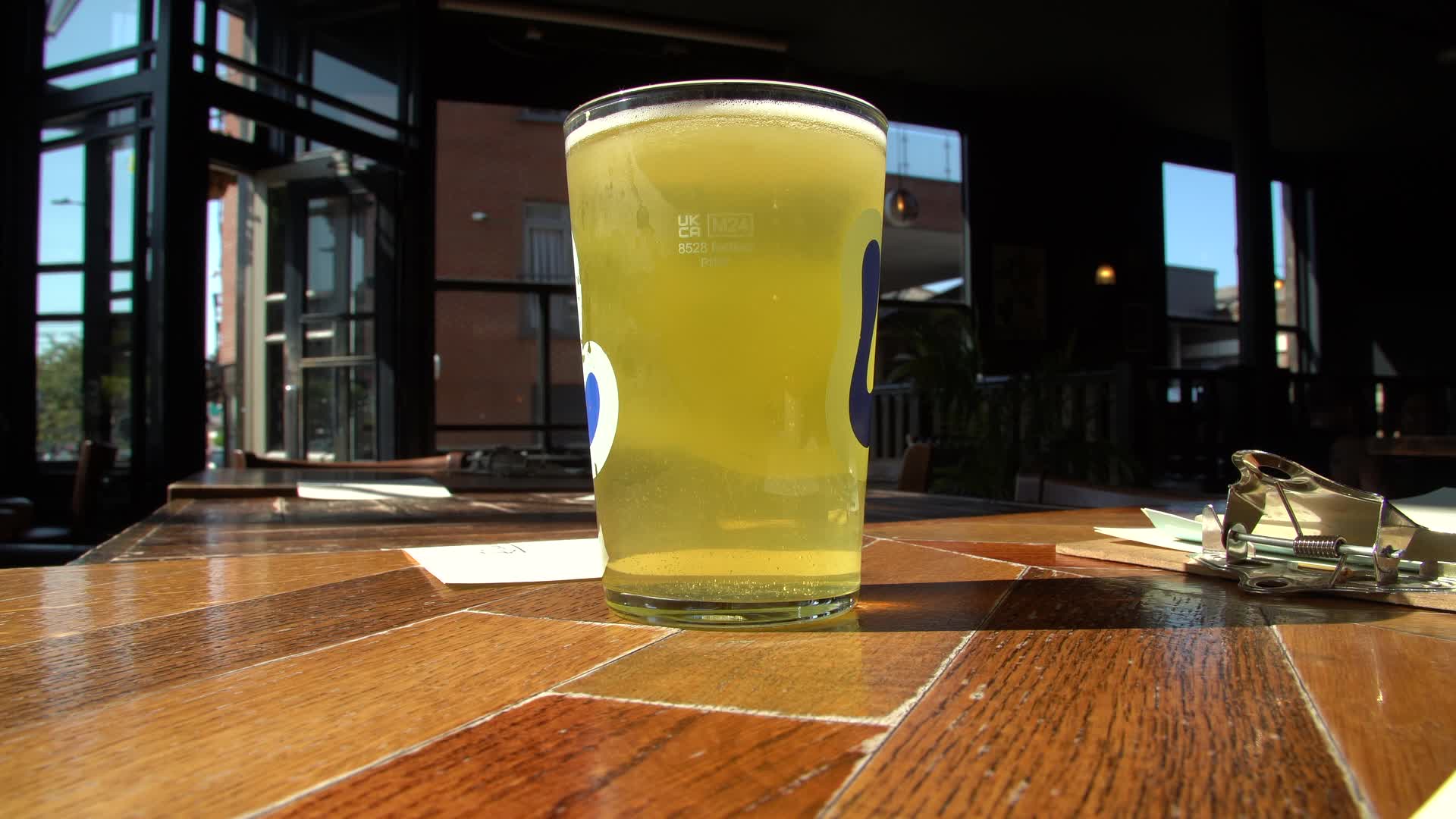 Pint of Beer Being Placed on a Table in a London Pub