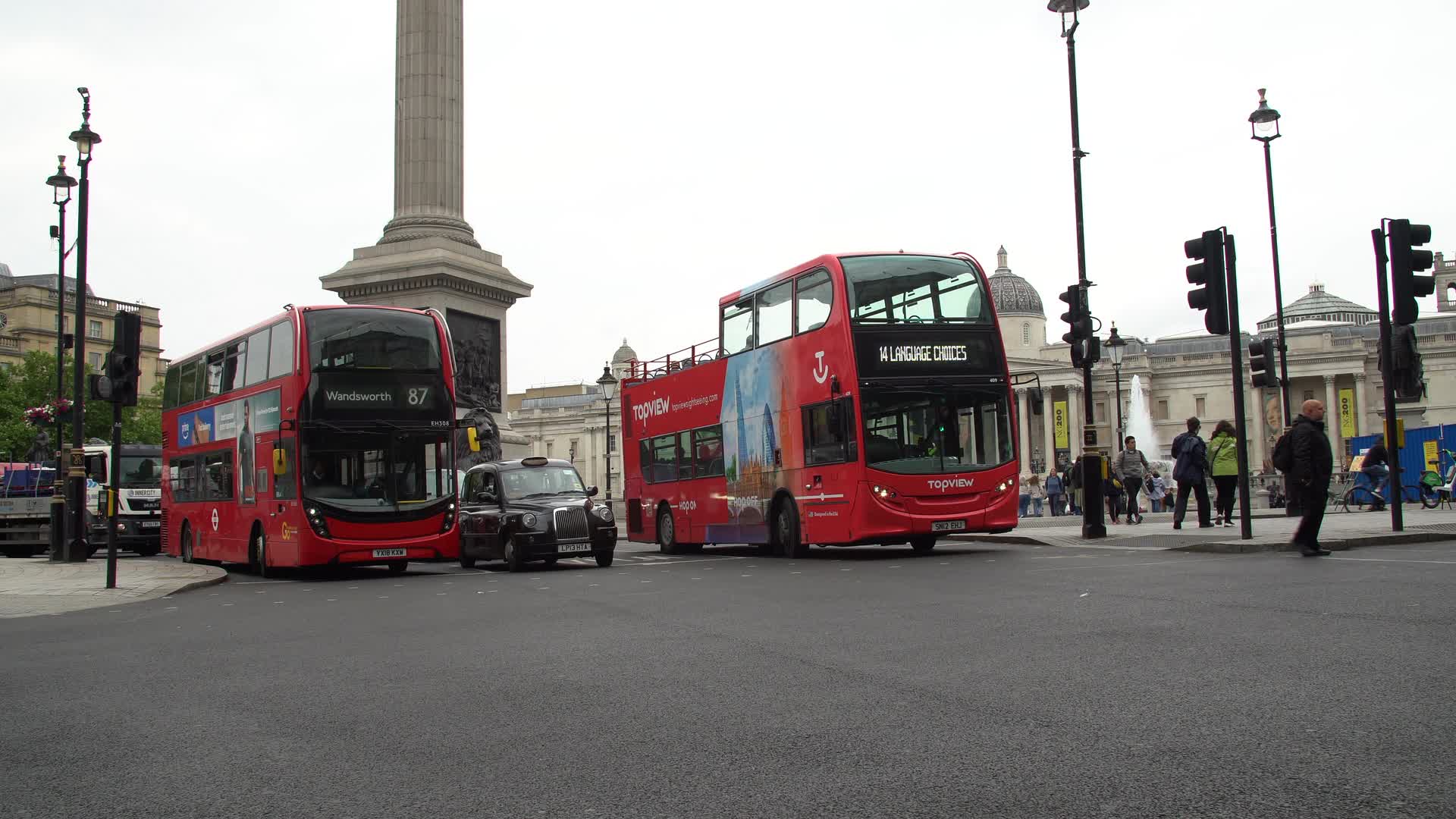 London Trafalgar Square Traffic with Iconic Red Buses