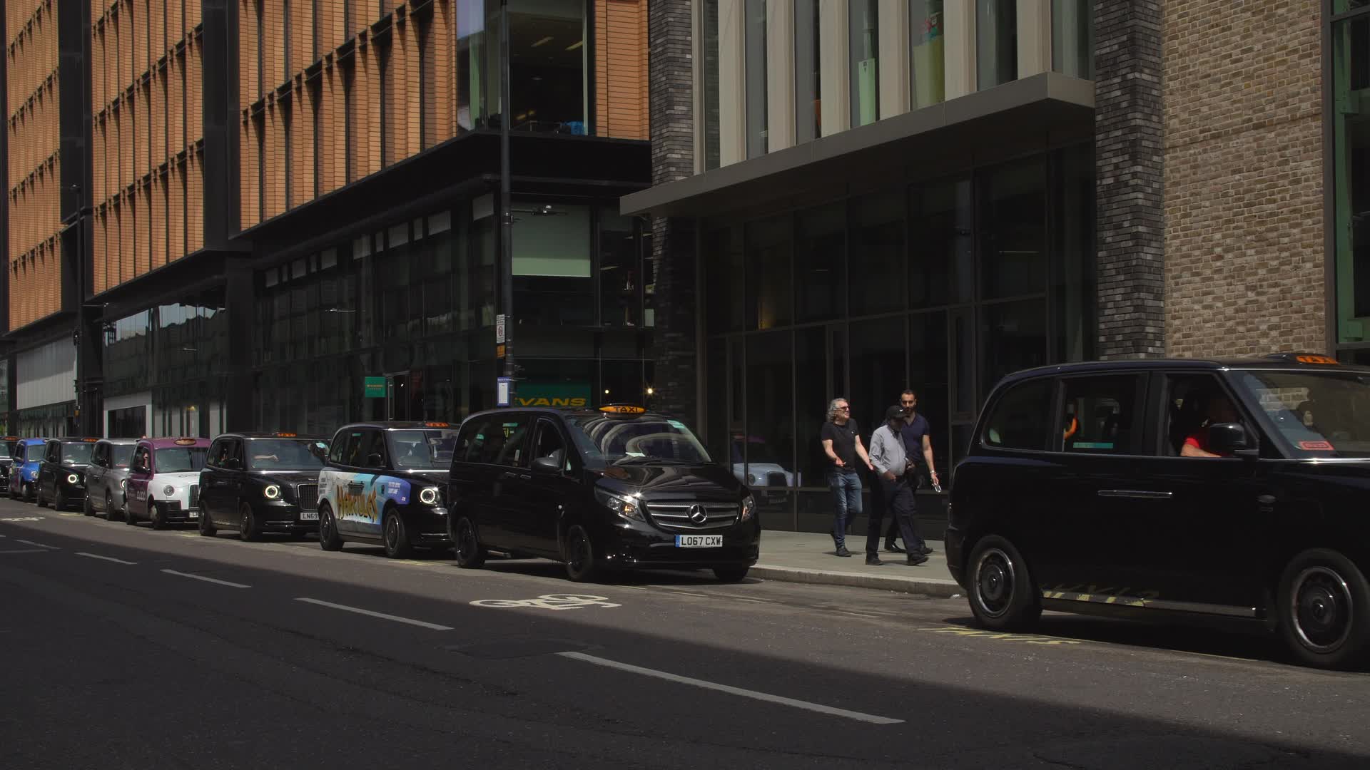 Black Cabs and Pedestrians on London Street
