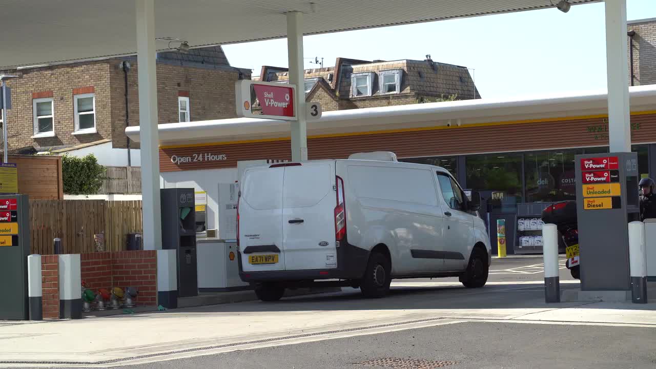 White Van Refueling at Shell Gas Station