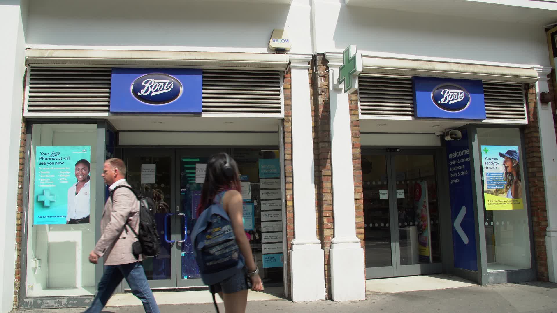 Exterior of Boots Pharmacy with Pedestrians Passing on London High Street