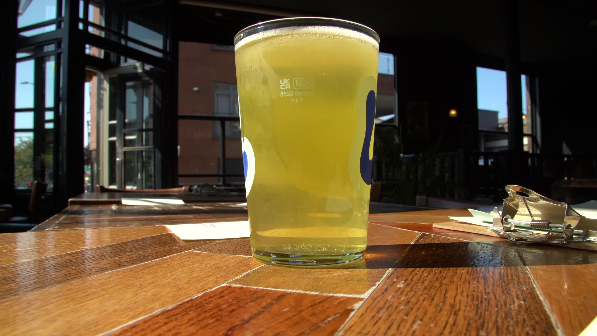 Pint of Beer on Pub Table in Sunlit Interior in London
