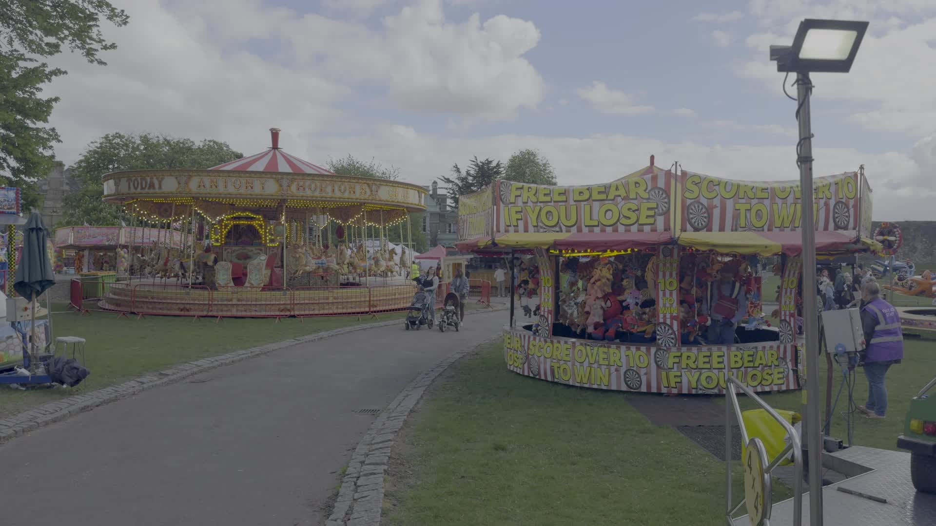 Colorful Carnival with Carousel and Game Stalls in Rochester