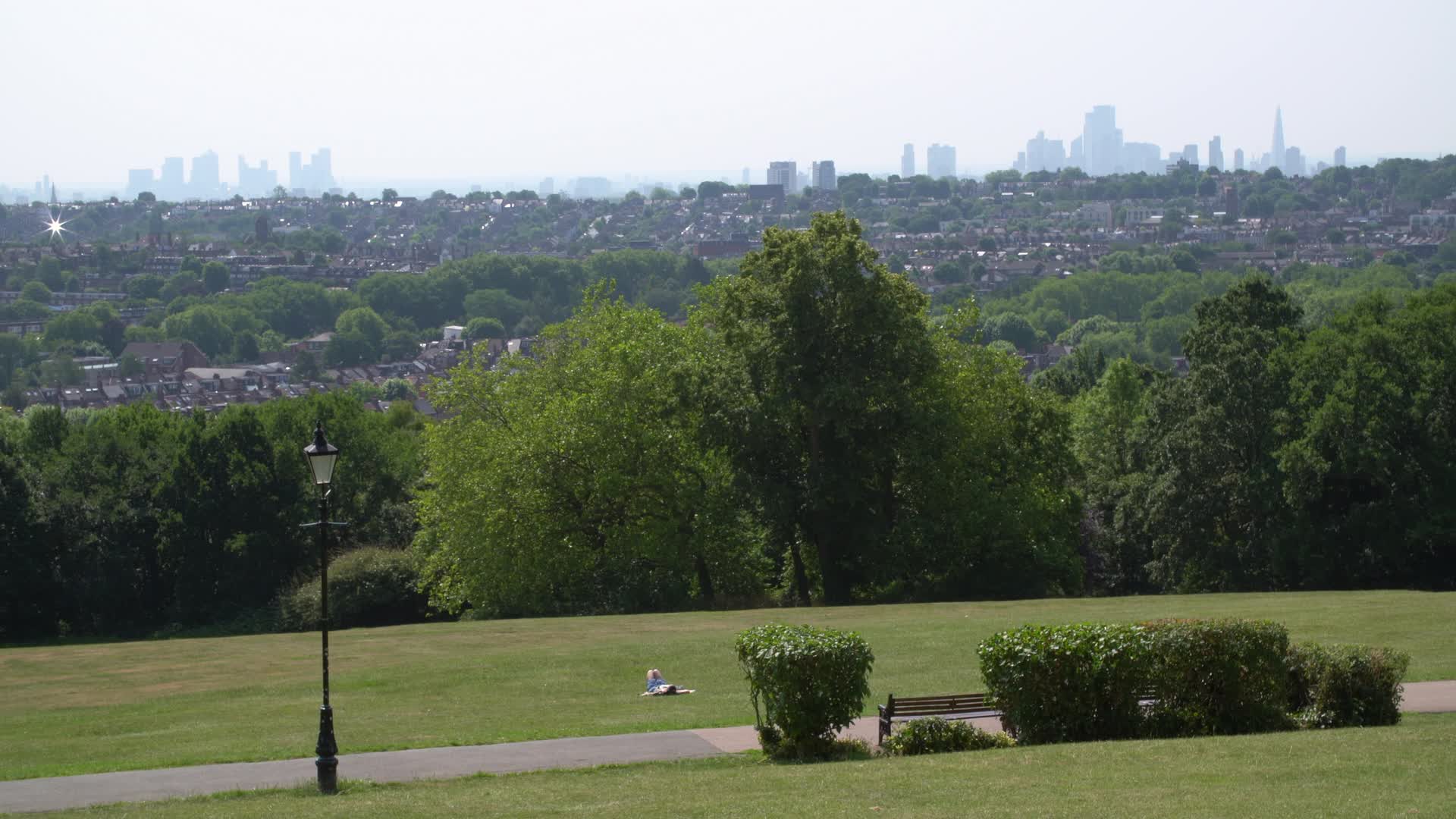 Sunny Day at London Park with City Skyline