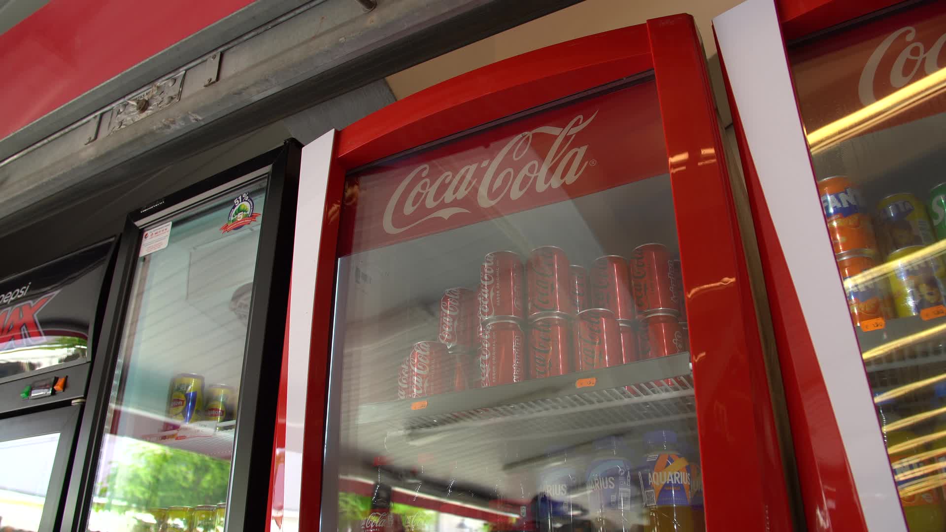 Coca-Cola Cans in Convenience Store Refrigerator