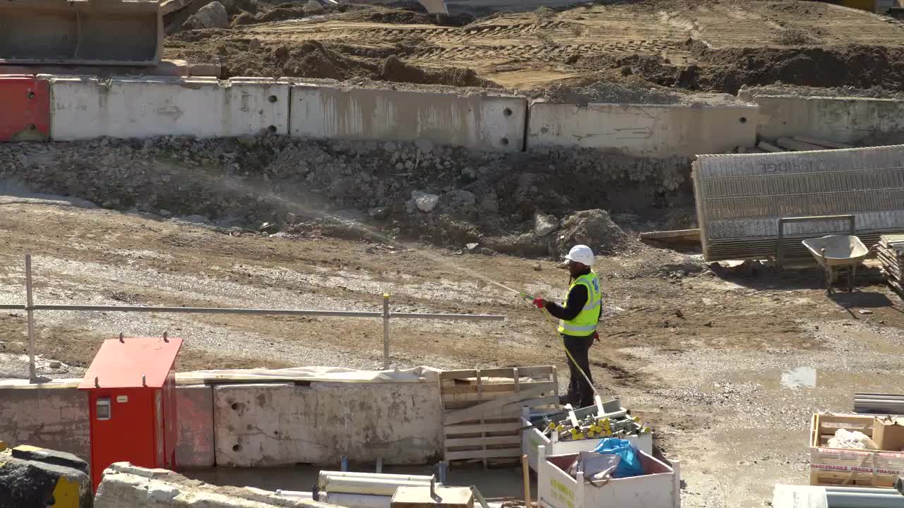 Construction Site Worker Managing Dust Control