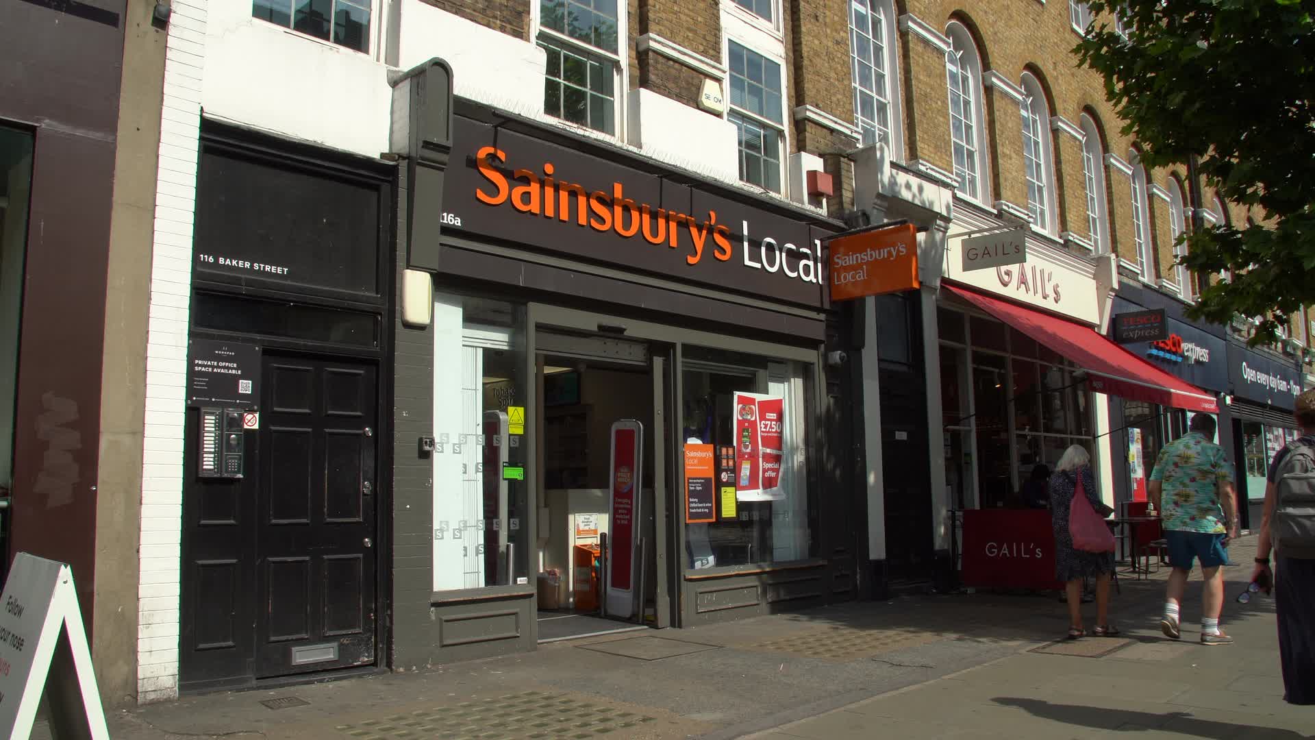Exterior of Sainsbury's Local on Bustling Street in London