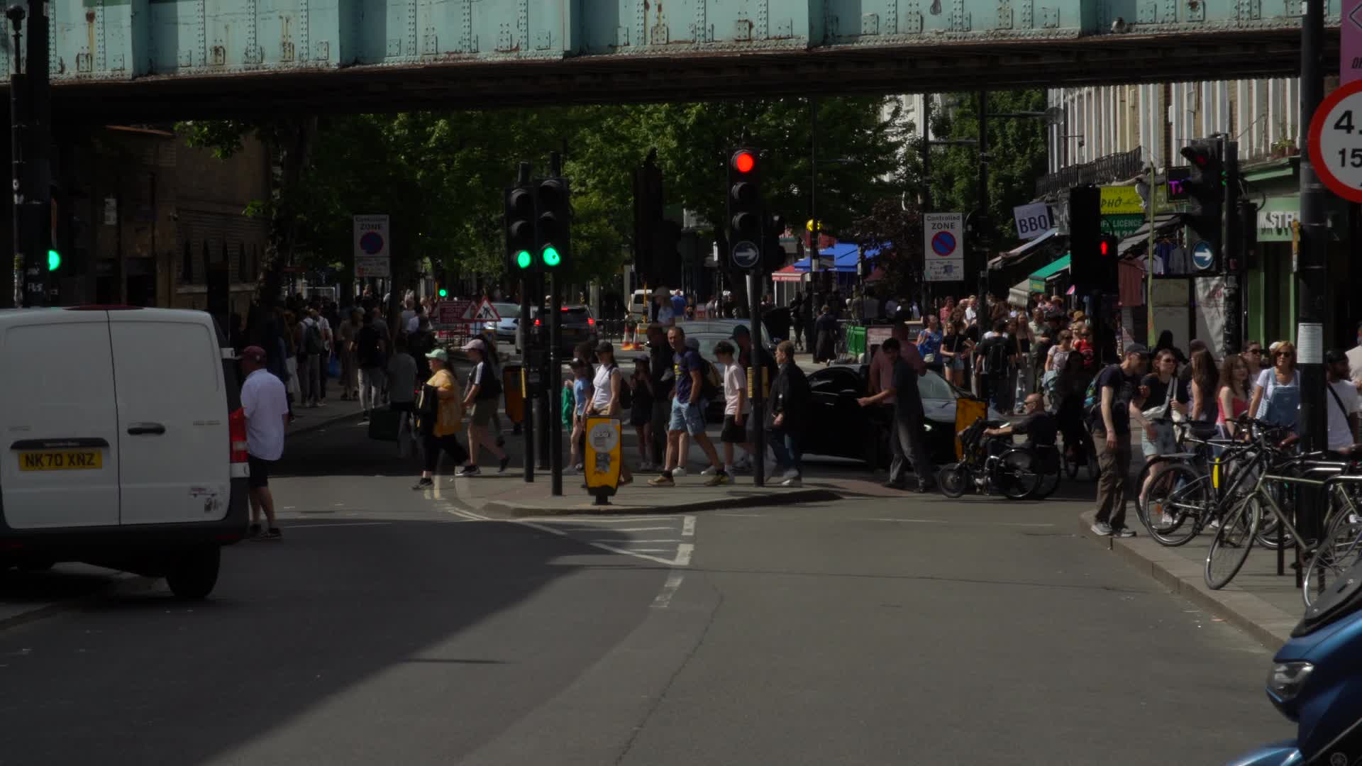 Close of Camden Lock Bridge in London and Busy Street Scene