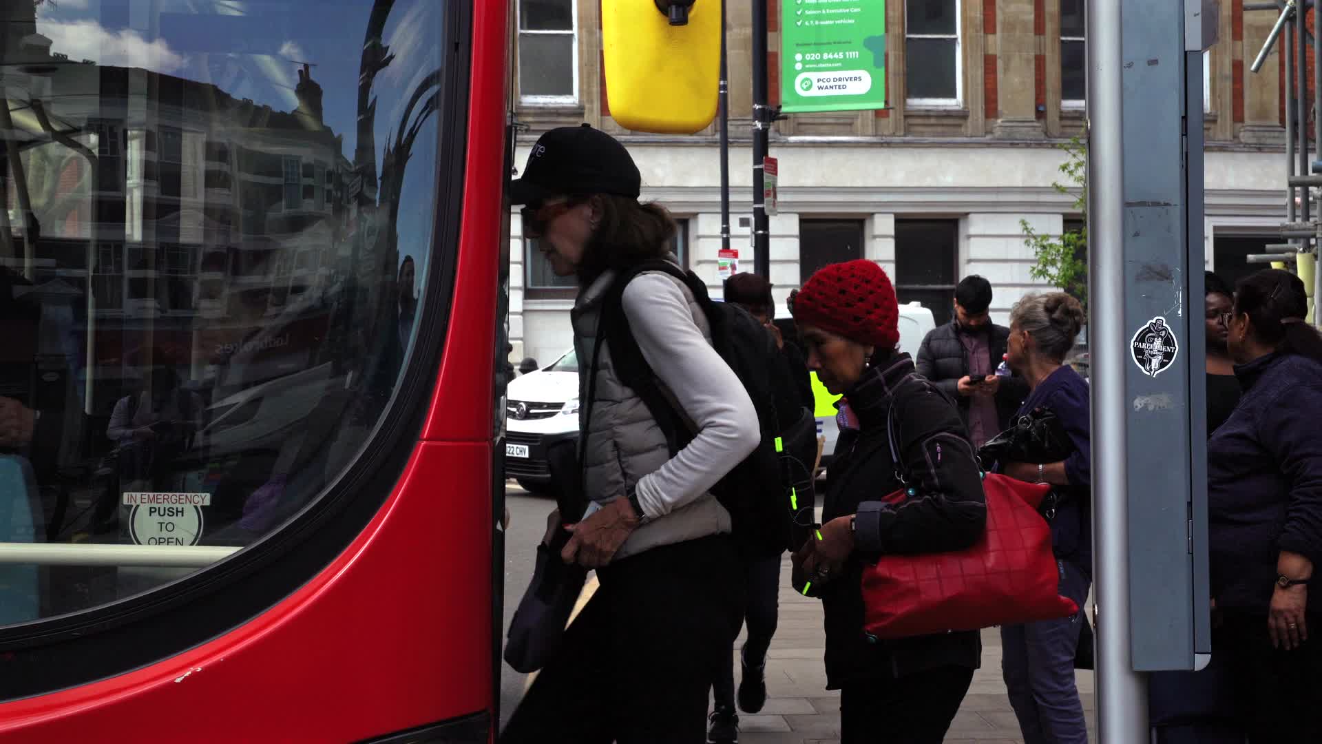 London Commuters Boarding Red Double-Decker Buses