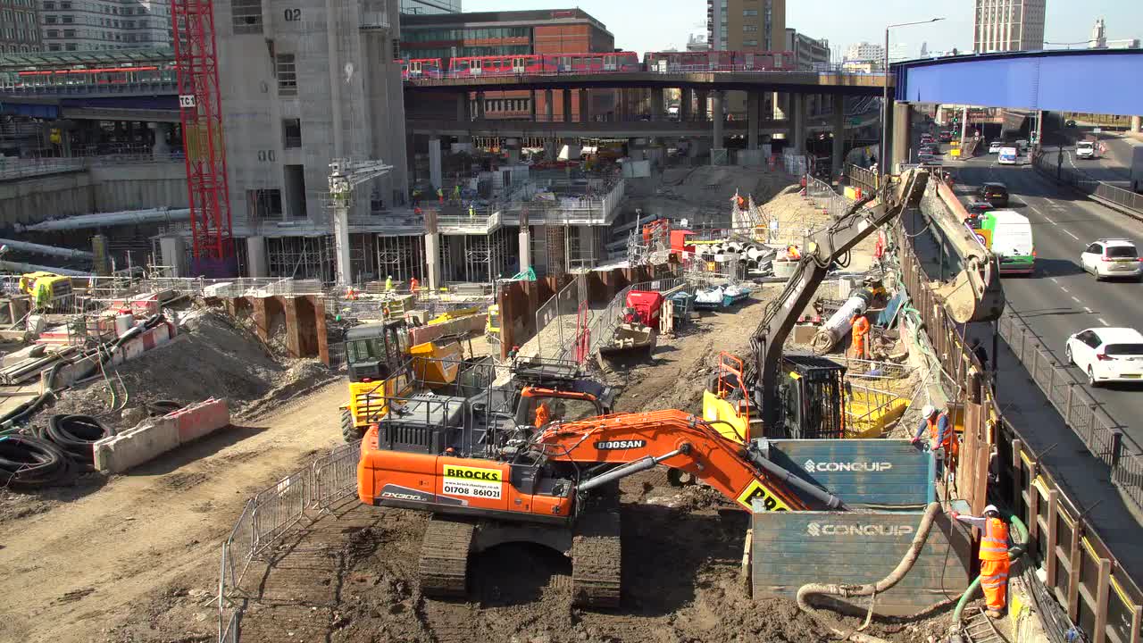 Urban Construction Site with Heavy Machinery and Workers