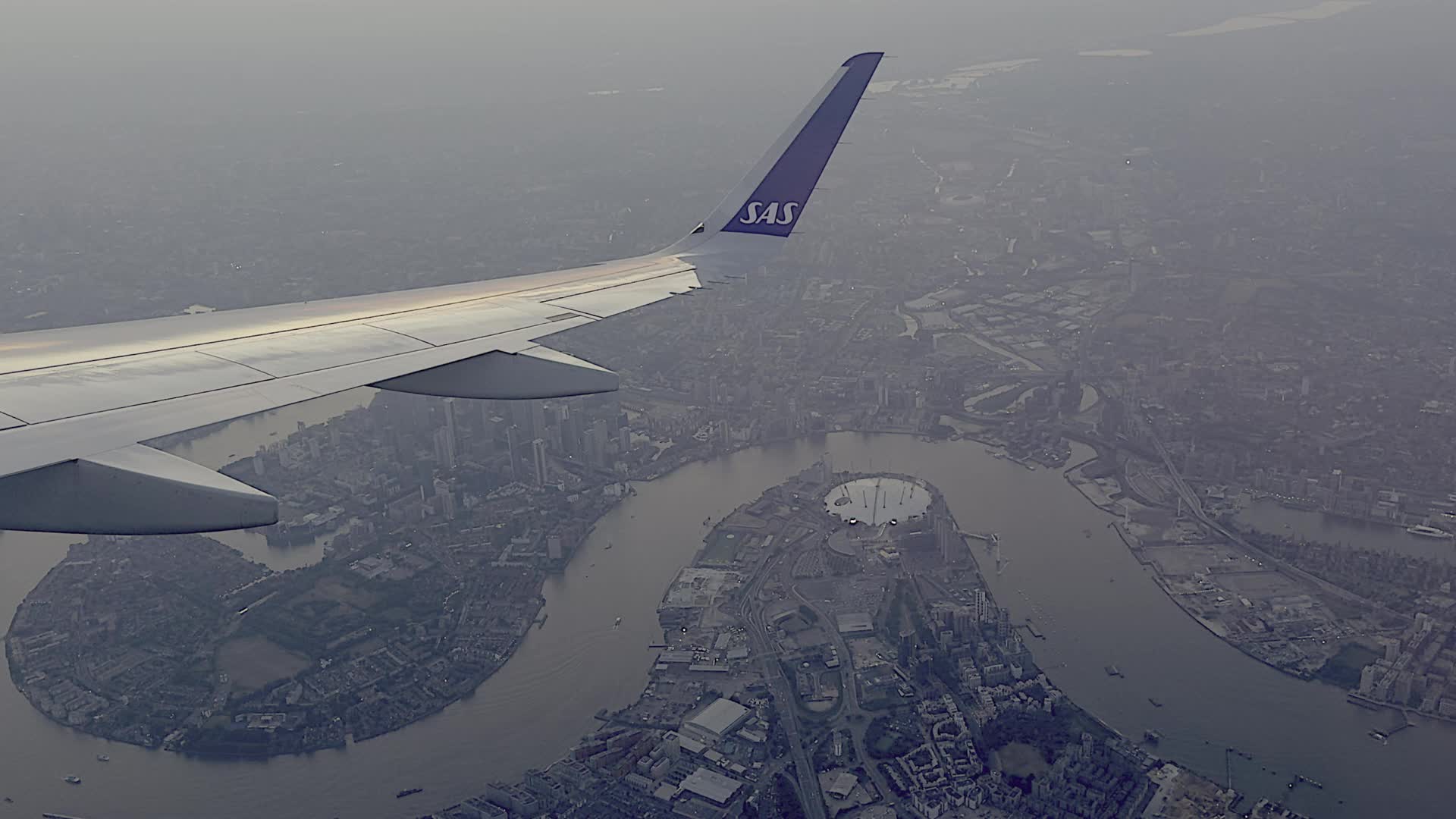 Aerial View of London Skyline with Aircraft Wing