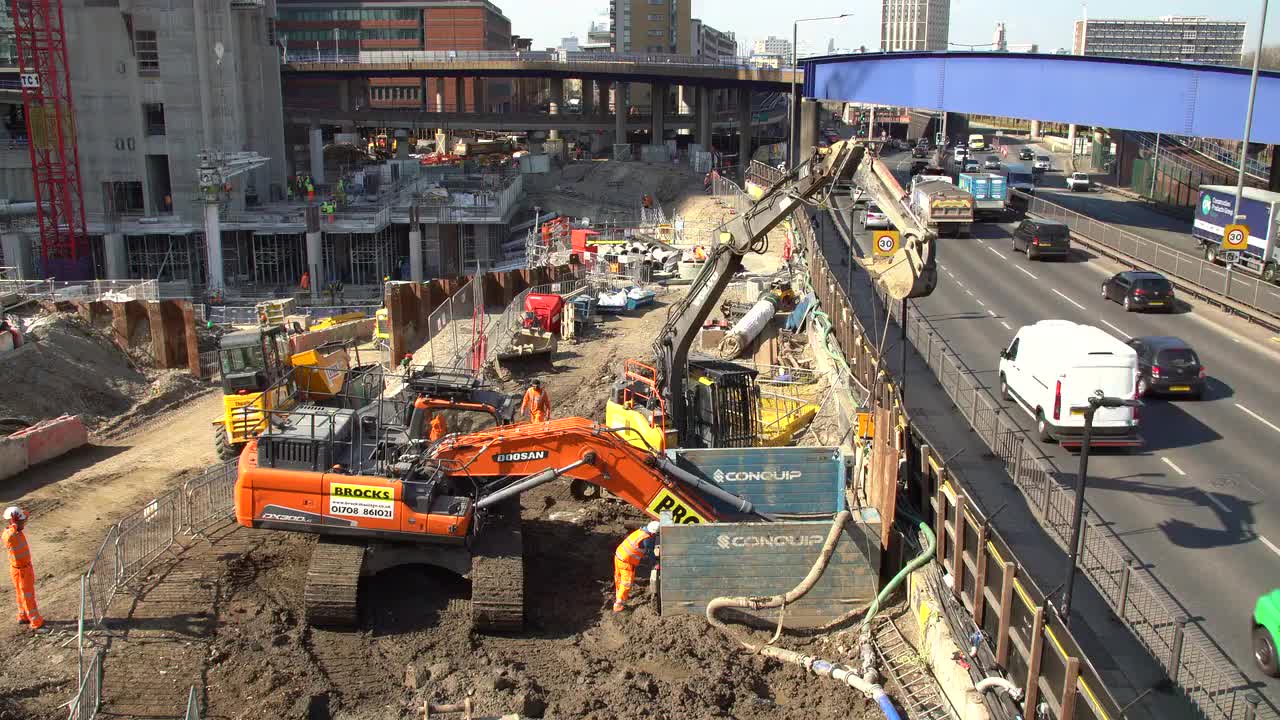 Urban Construction Site with Traffic in Background