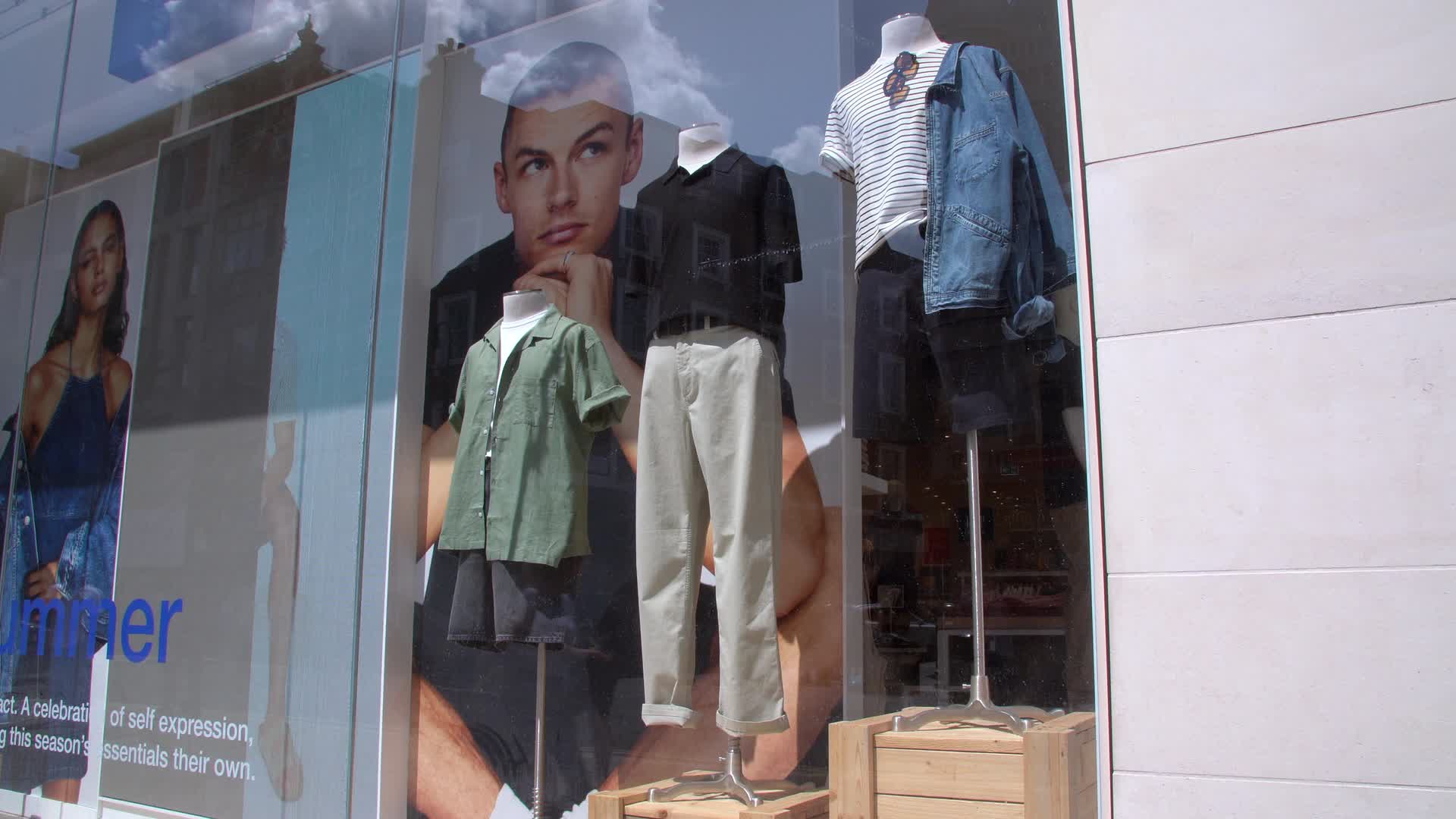 Fashion Storefront with Mannequins and Posters