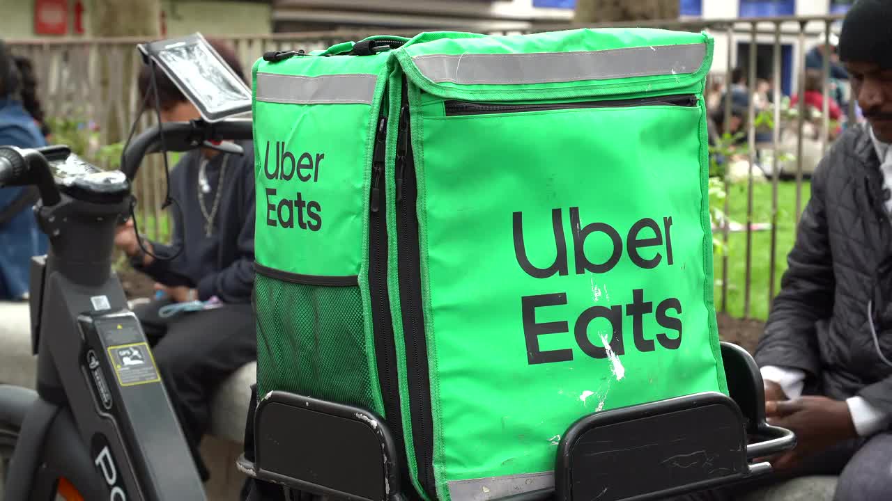 Urban Delivery Scene with Uber Eats Courier