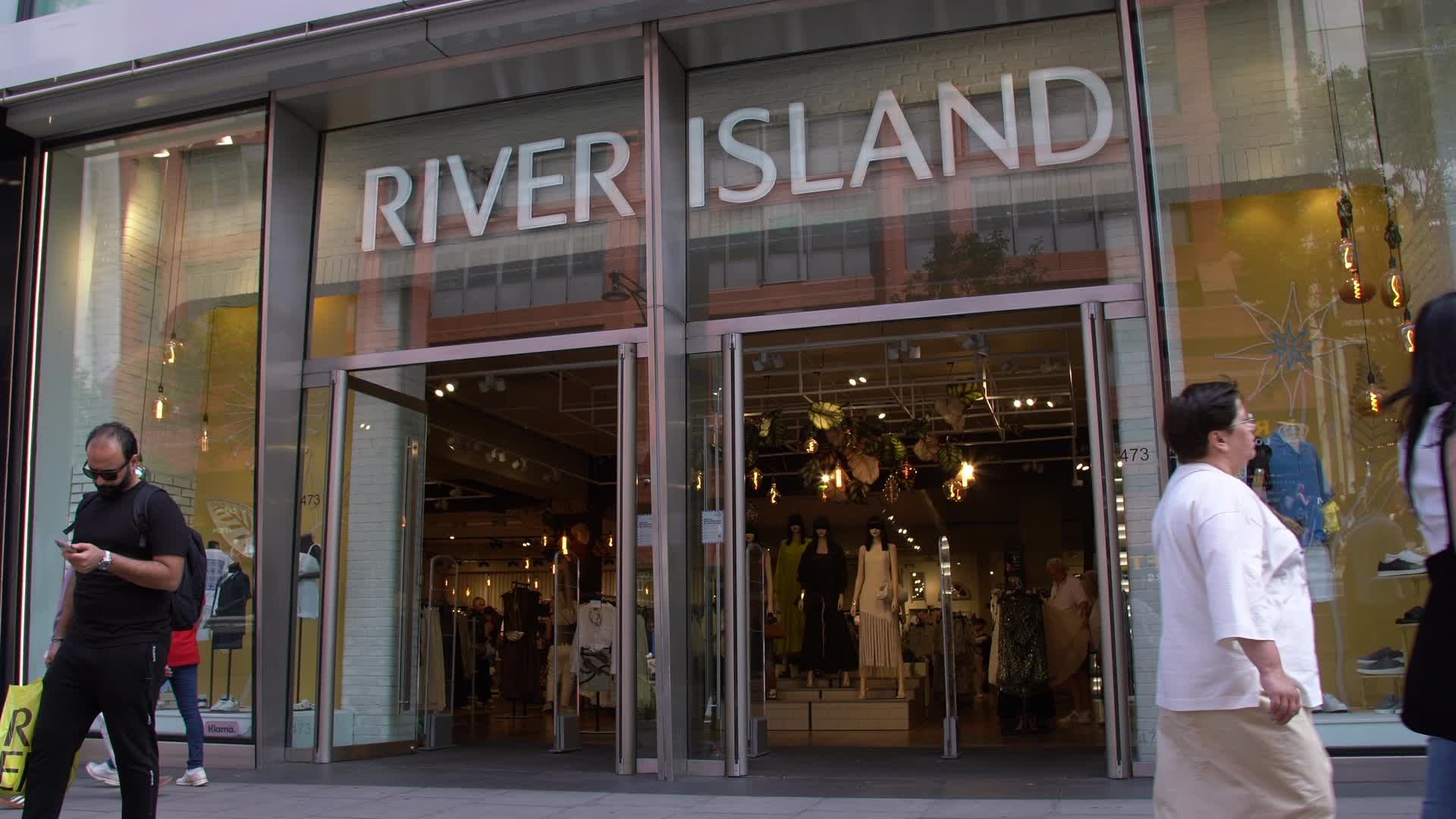 River Island Storefront with Shoppers
