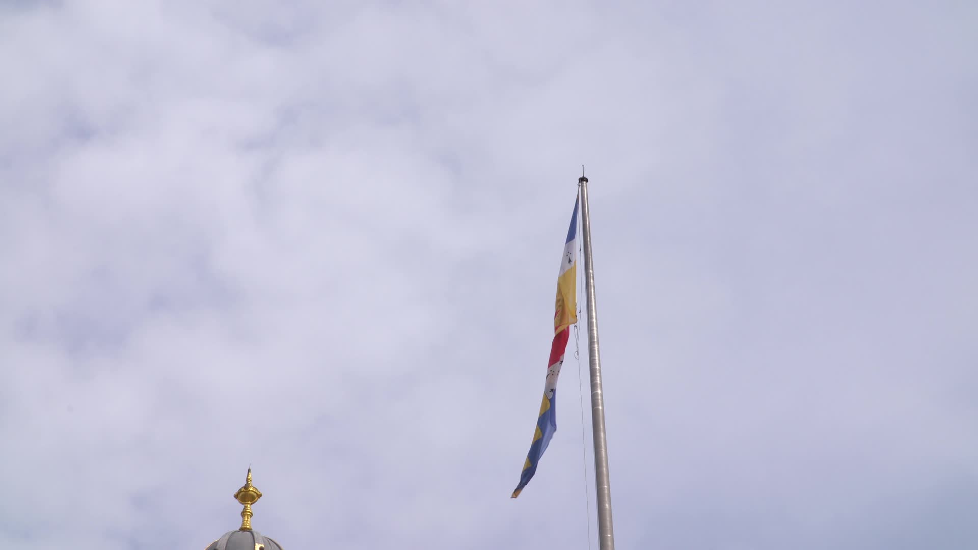 Close-Up of Birmingham Flag Above Museum Against Cloudy Sky