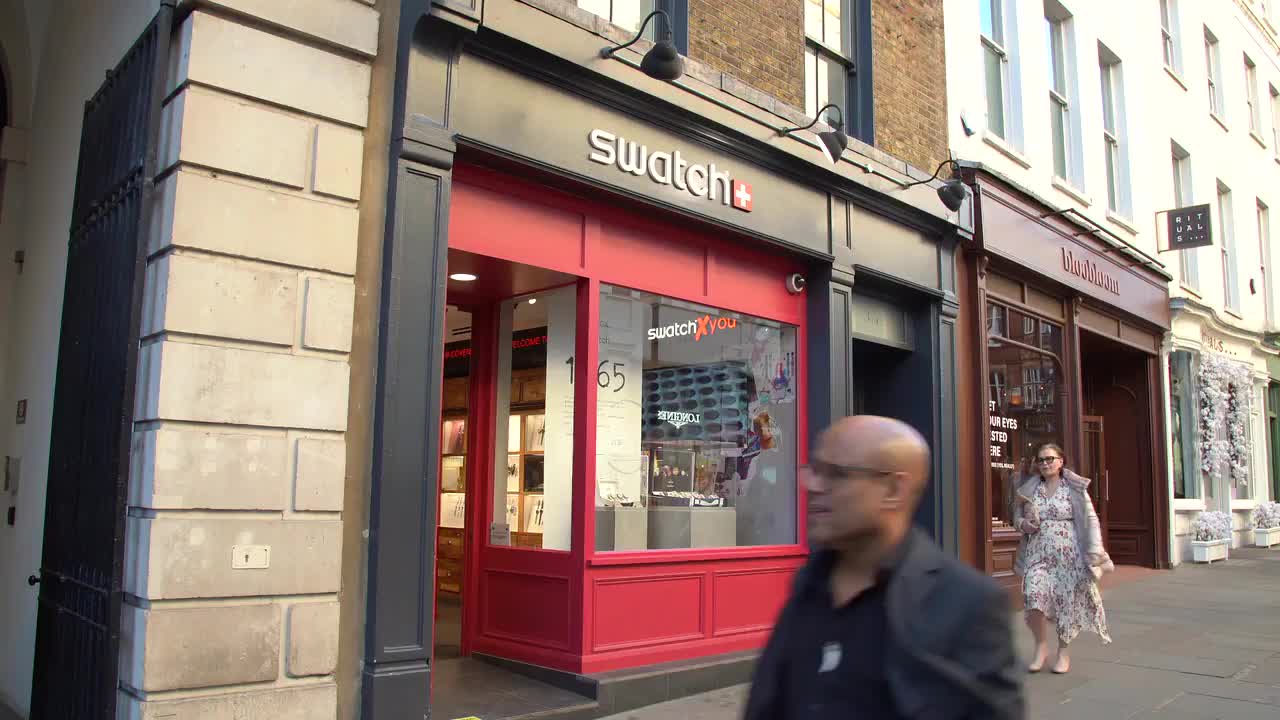 Swatch Storefront in Busy Urban Street 4K Footage