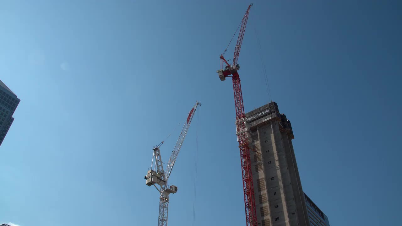 Urban Construction Cranes Against Blue Sky