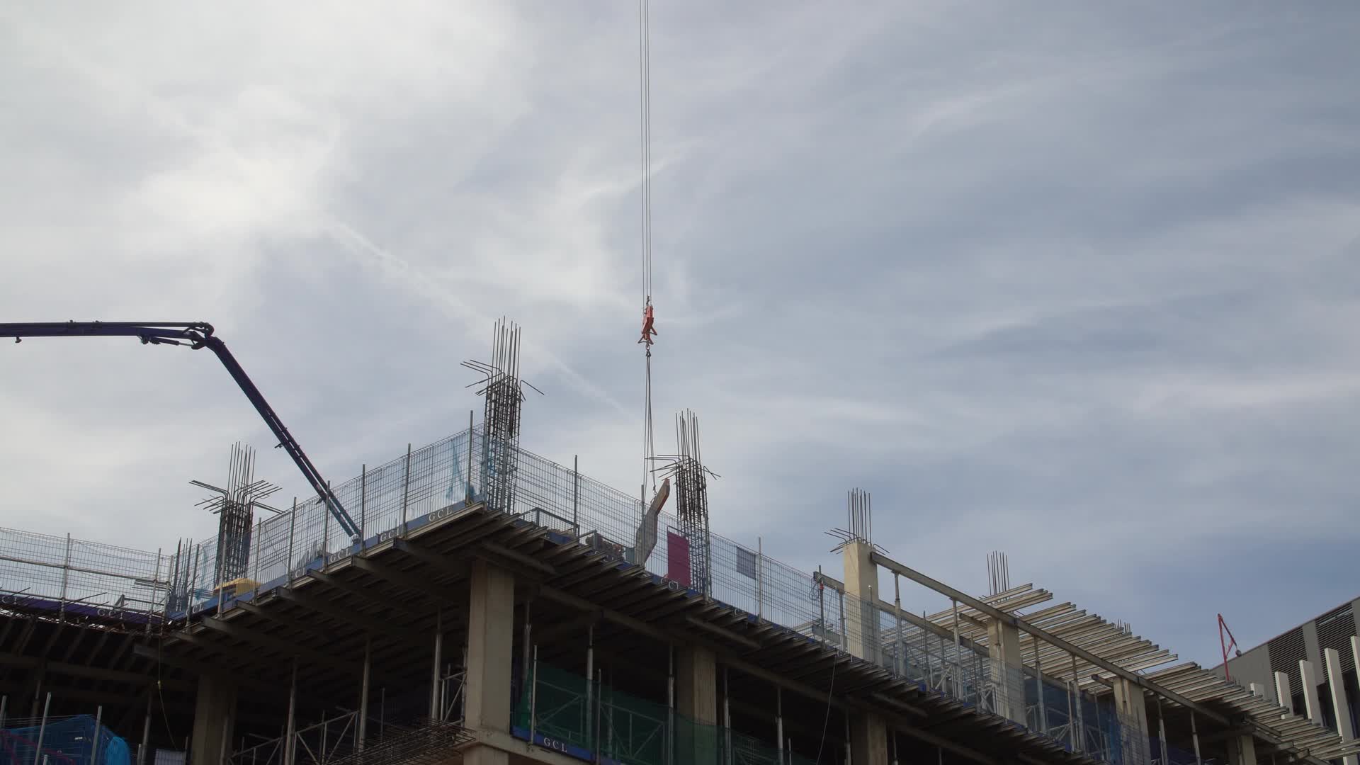 Construction Site by Canal with Crane and Building Framework in London