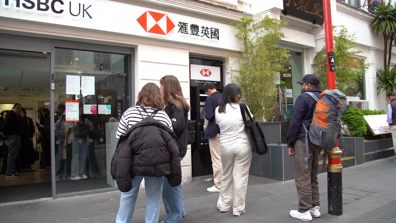 People Lining Up Outside HSBC Bank in Urban Setting