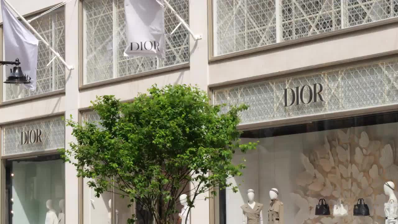 Dior Storefront with Mannequins and Greenery in London