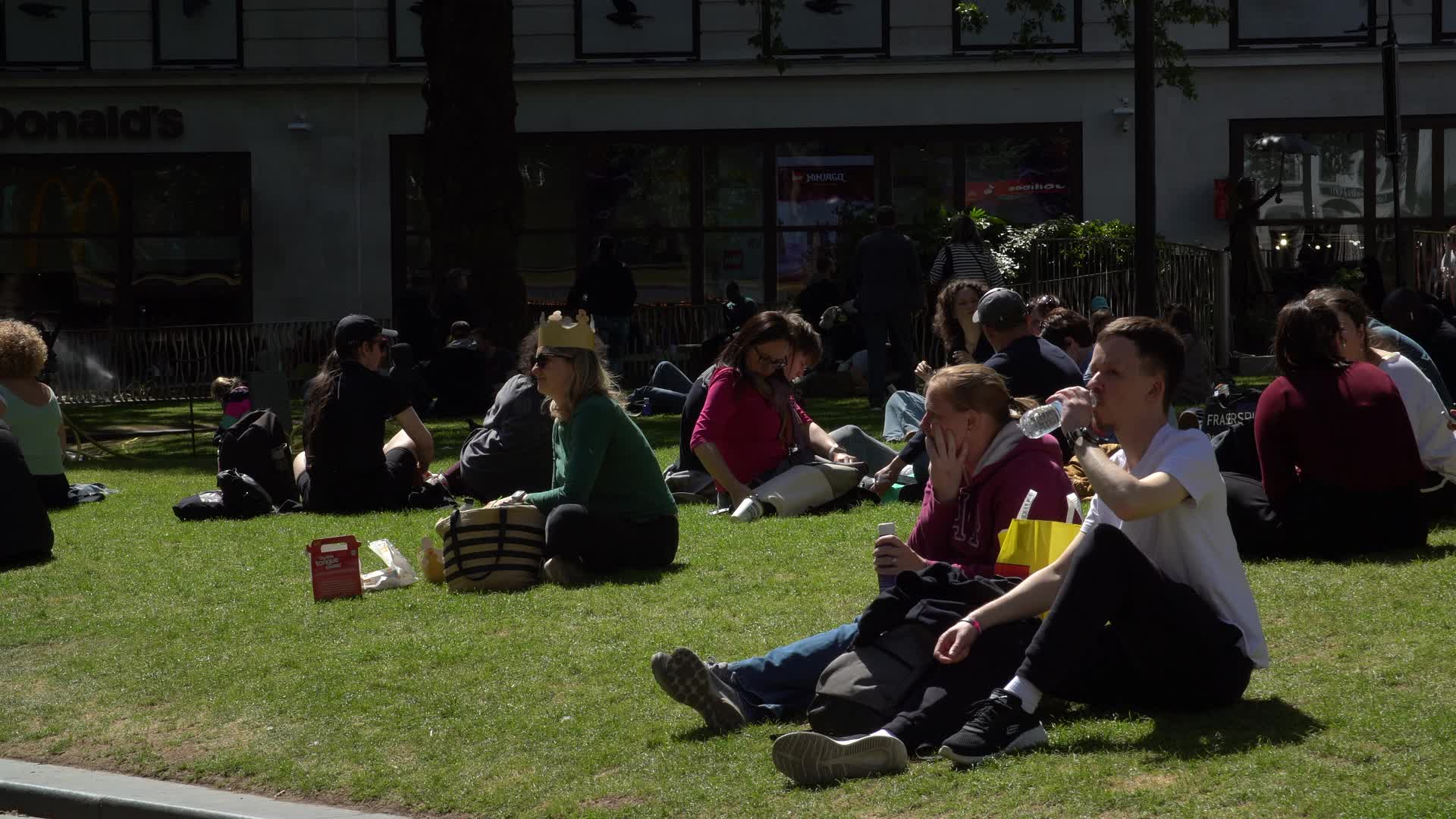Leicester Square Park Visitors Enjoying Sunny Day