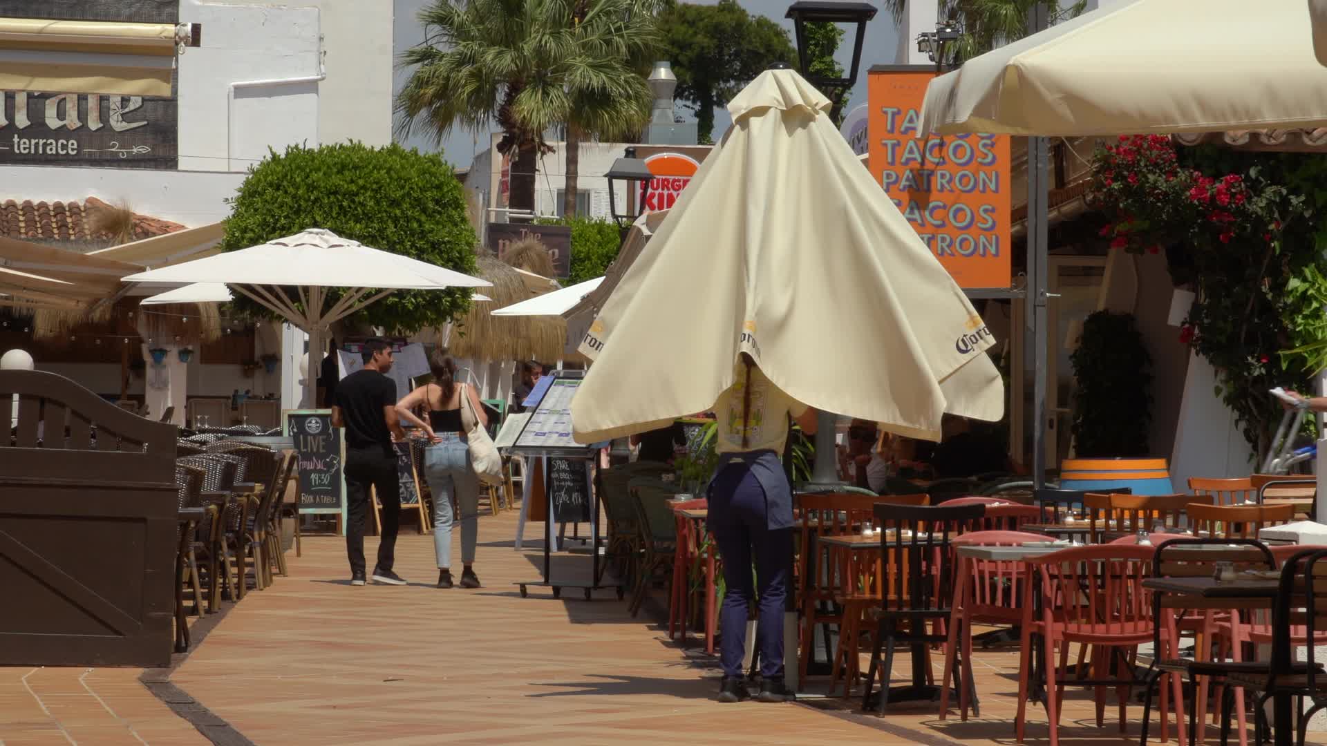 Outdoor Cafe with Patrons on Sunny Street