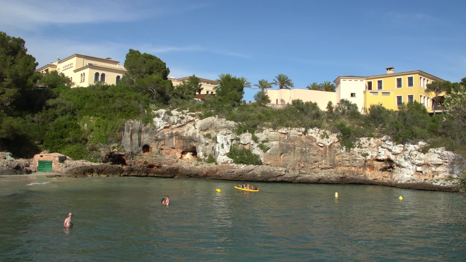 Sunny Day at Cala Ferrera Beach, Mallorca, Spain with Swimmers and Kayakers