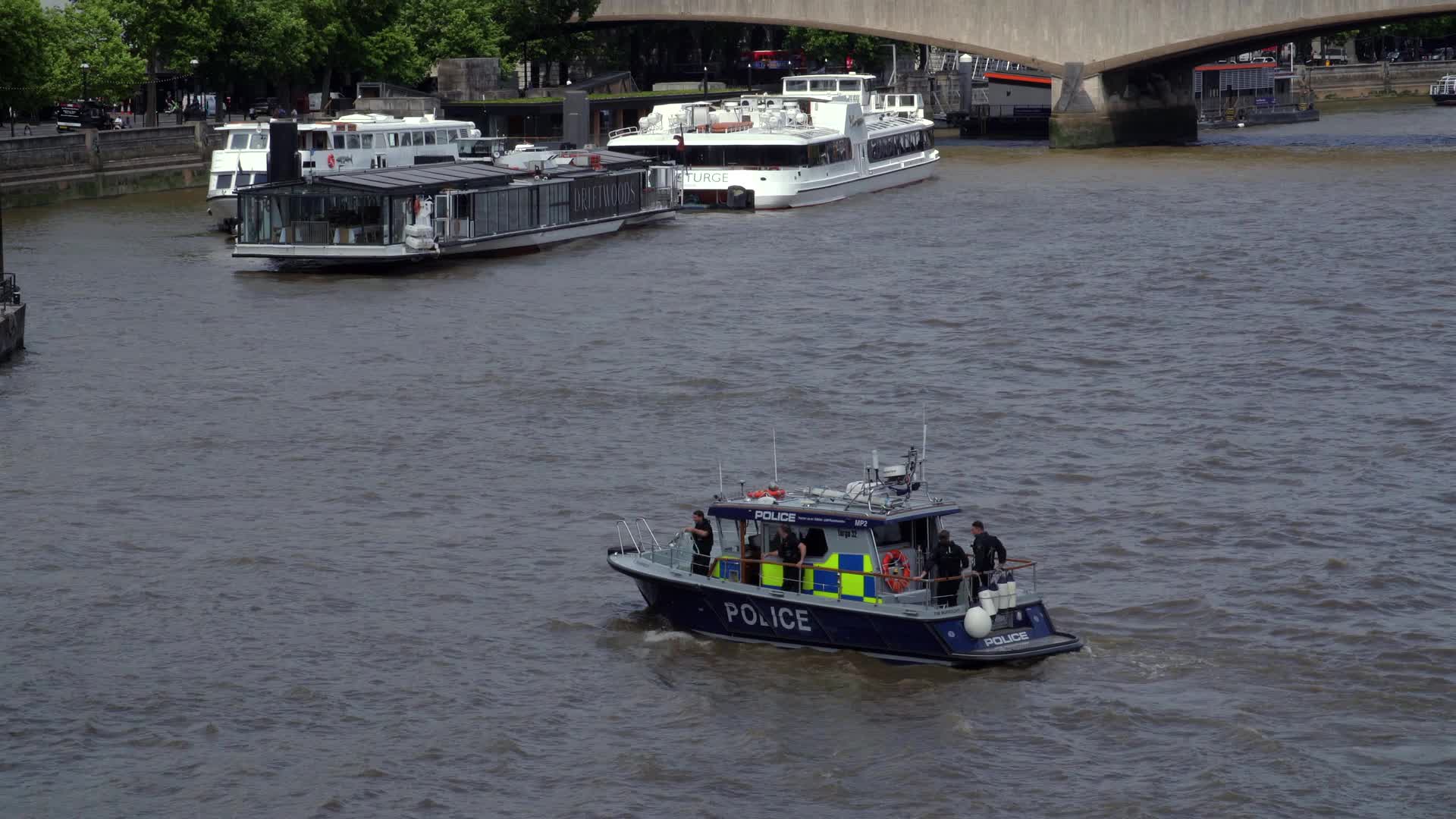 Police Boat on River with Cruise Ships