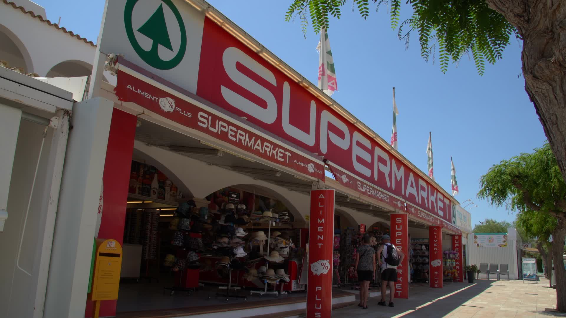 Busy SPAR Supermarket Entrance on Sunny Day in Cala d'Or, Mallorca, Spain