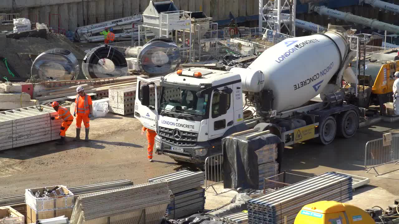 Busy Urban Construction Site with Concrete Mixer and Workers