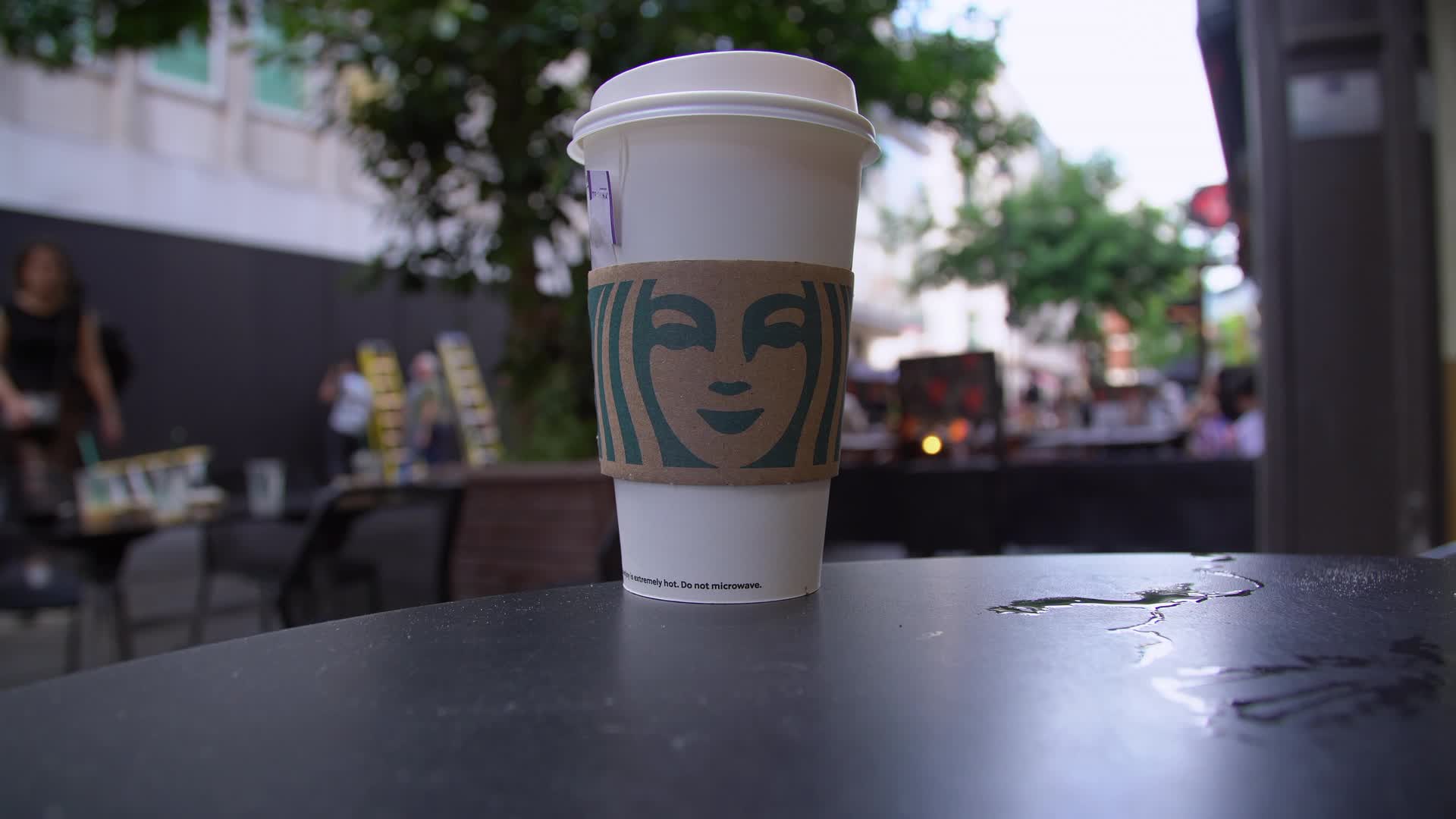 Outdoor Cafe Scene with Starbucks Cup