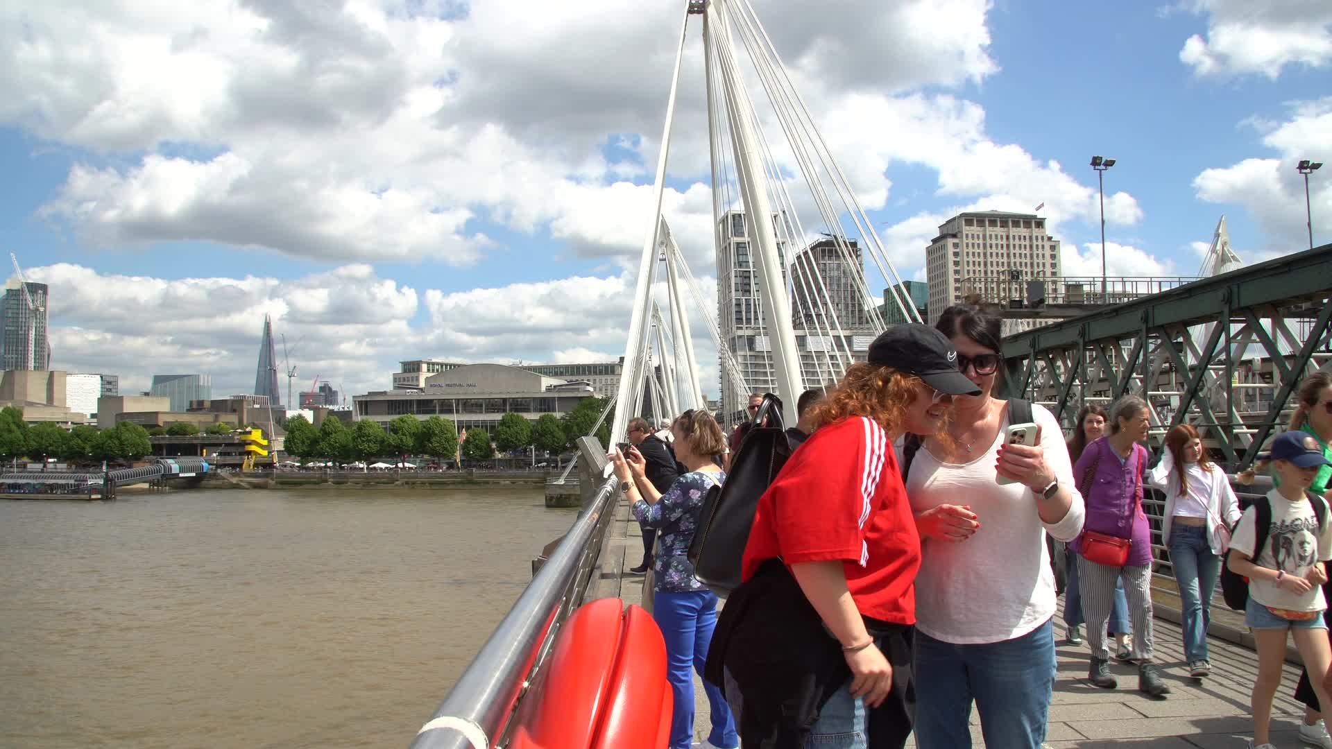 Tourists on London Bridge with City Skyline