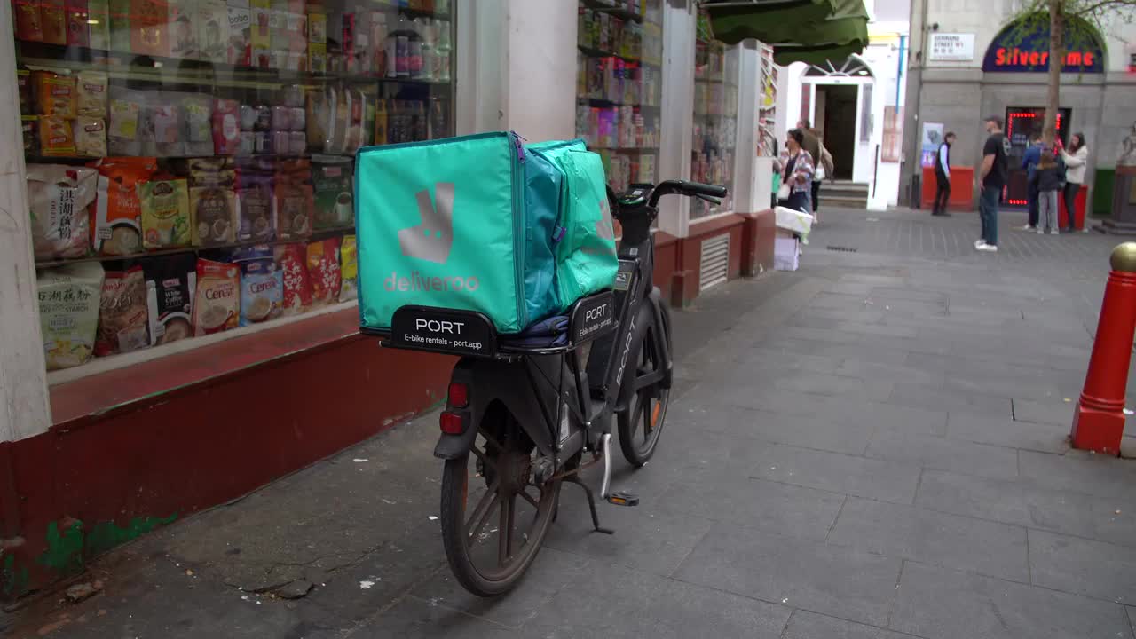 Urban Food Delivery: Deliveroo E-Bike in City Street