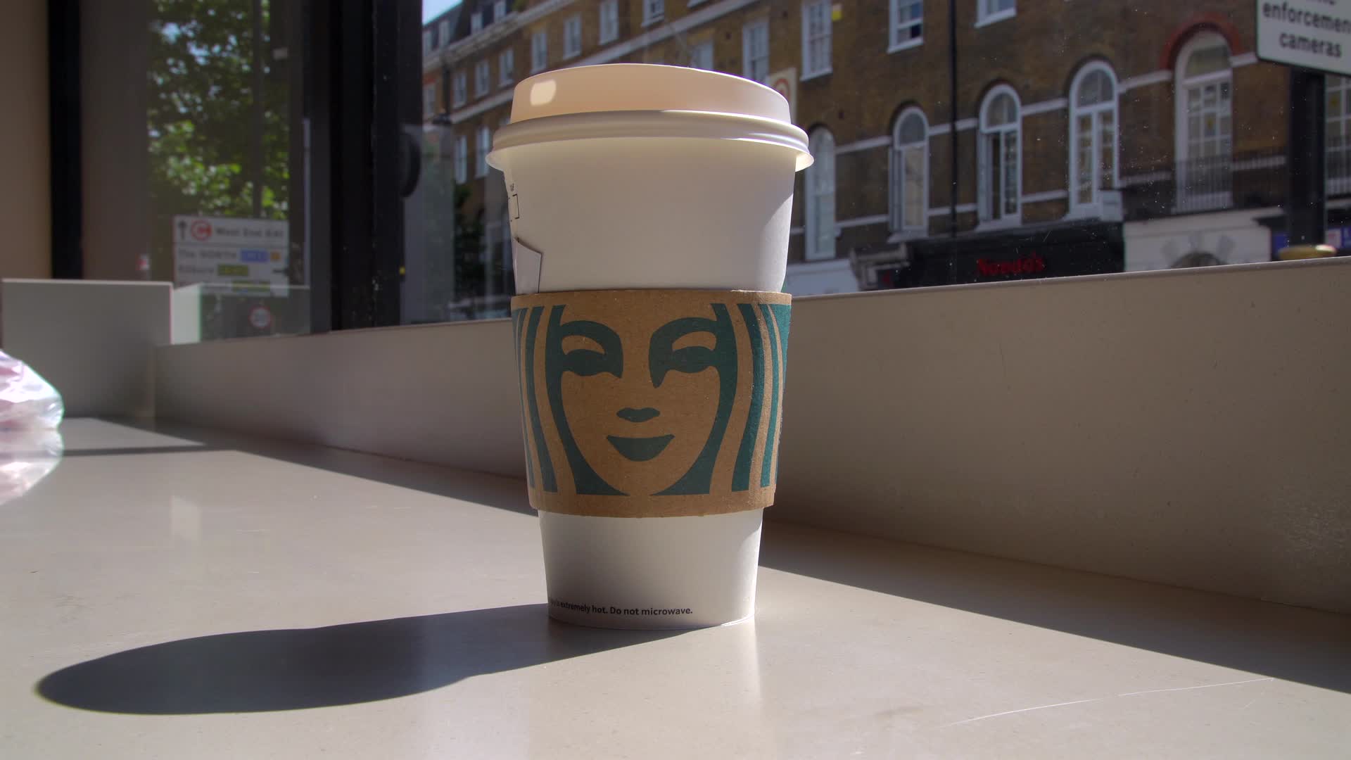 Starbucks Coffee Cup by Window