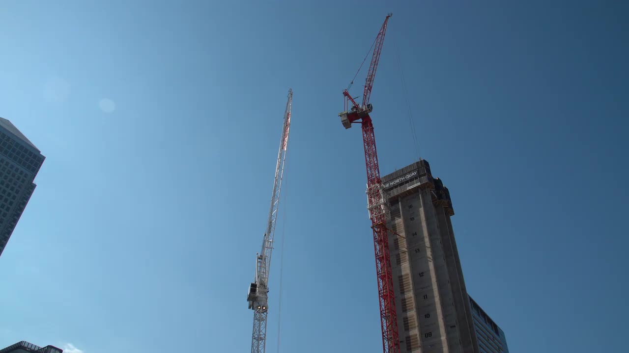 Urban Construction Site with Tower Cranes on Clear Day