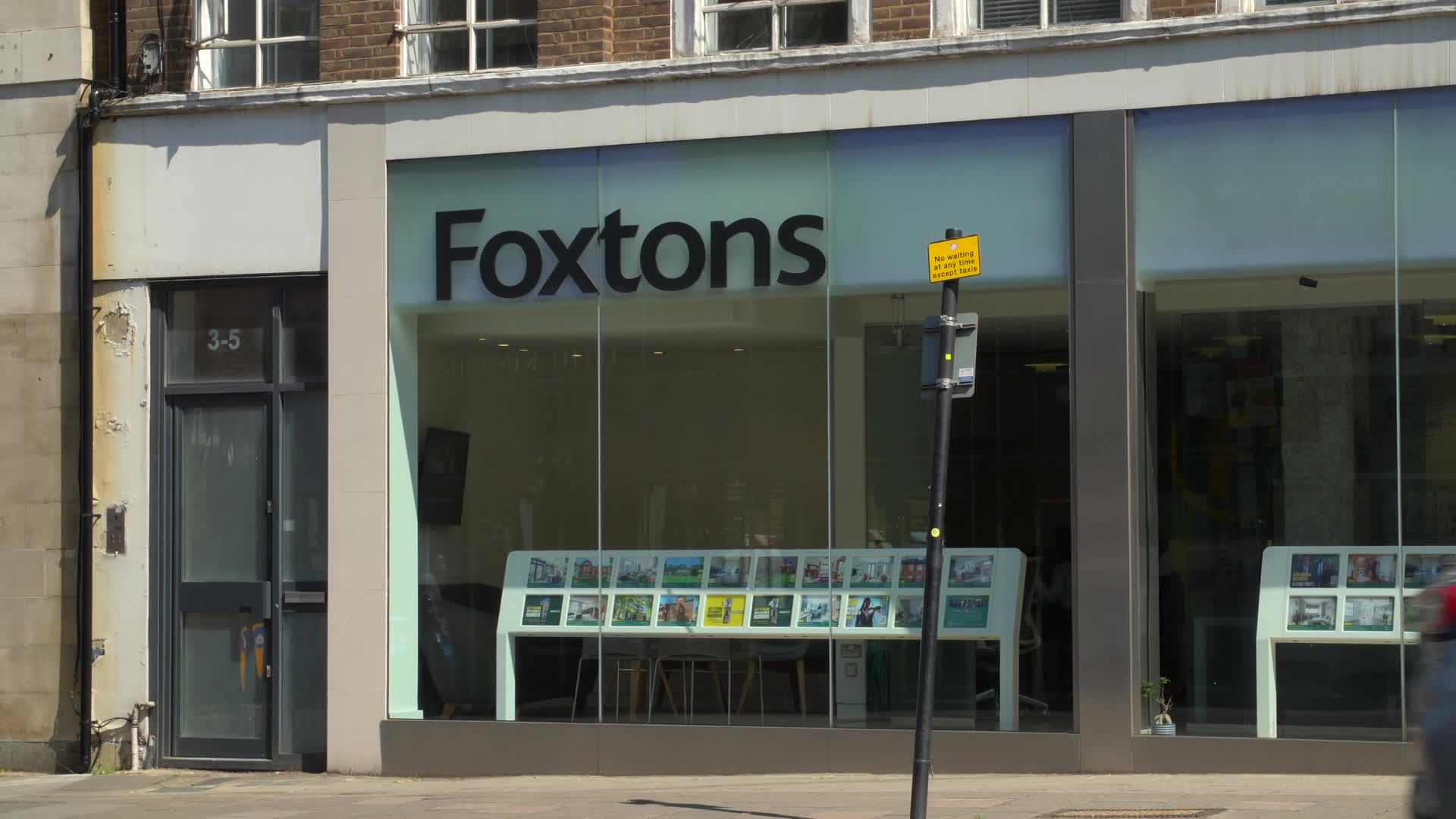 Foxtons Real Estate Storefront in Sunny Urban Setting in London, UK