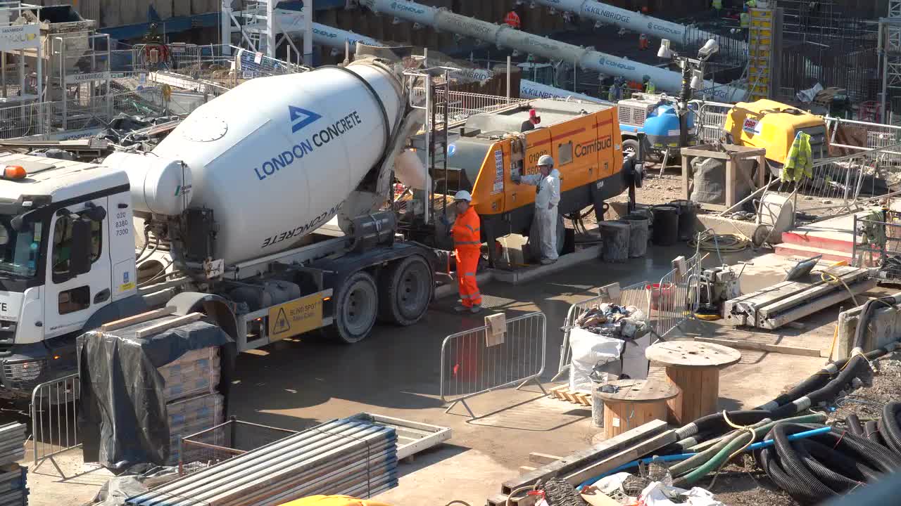 Urban Construction Site with Cement Mixer and Workers
