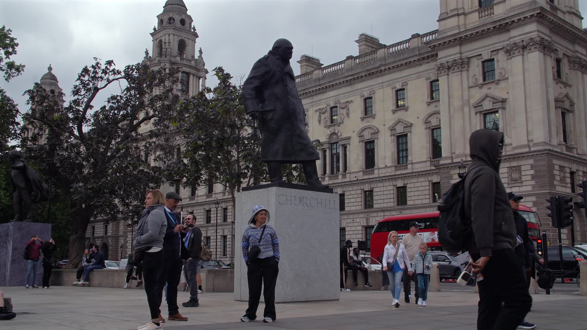 Statue of Winston Churchill in London with Tourists