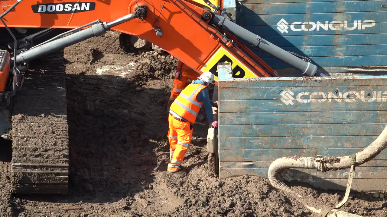 Heavy Machinery and Construction Workers at Site